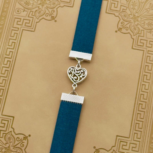 A silver heart charm on an elastic Bookband