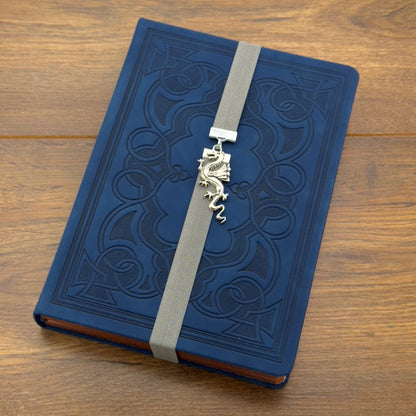 A silver dragon charm on a elastic Bookband