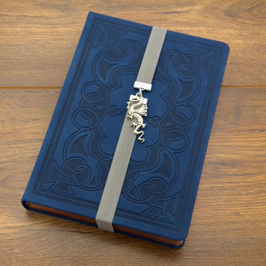 A silver dragon charm on a elastic Bookband