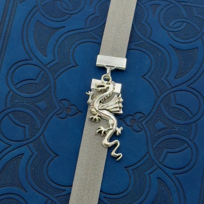 A silver dragon charm on a elastic Bookband