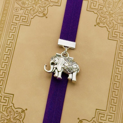 Silver elephant charm on a elastic Bookband