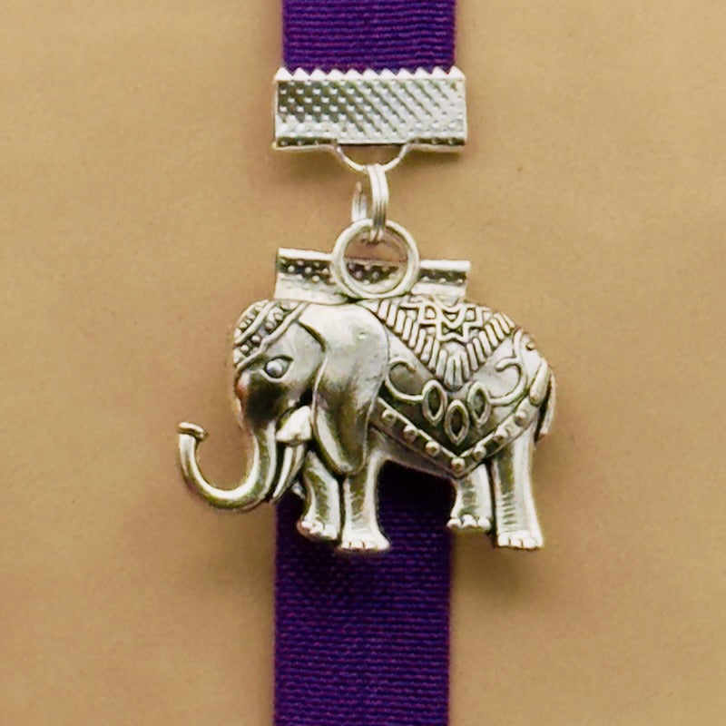 Silver elephant charm on a elastic Bookband
