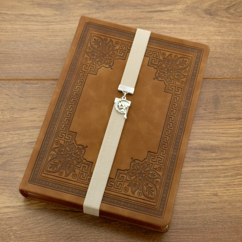 A silver fairy sat in a moon charm on an elastic Bookband