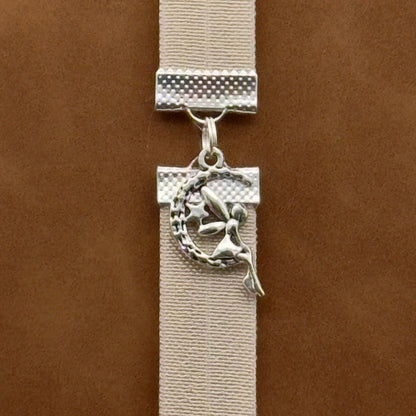 A silver fairy sat in a moon charm on an elastic Bookband