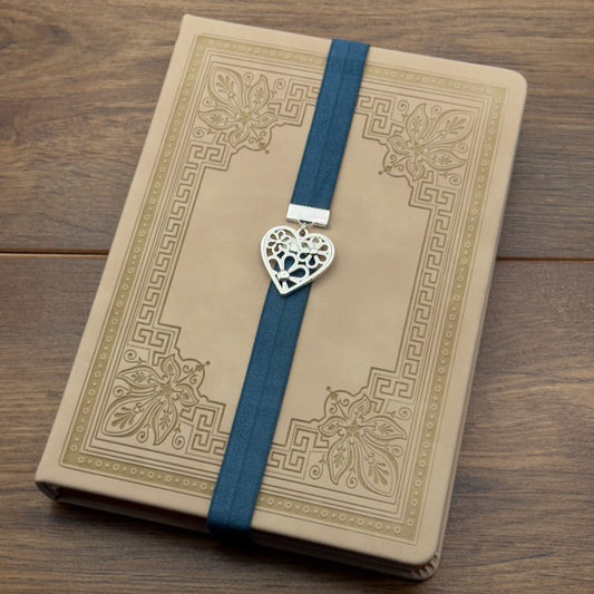 A silver heart containing flowers charm on a elastic Bookband