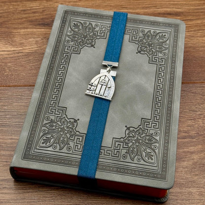 A silver arched door charm on an elastic Bookband