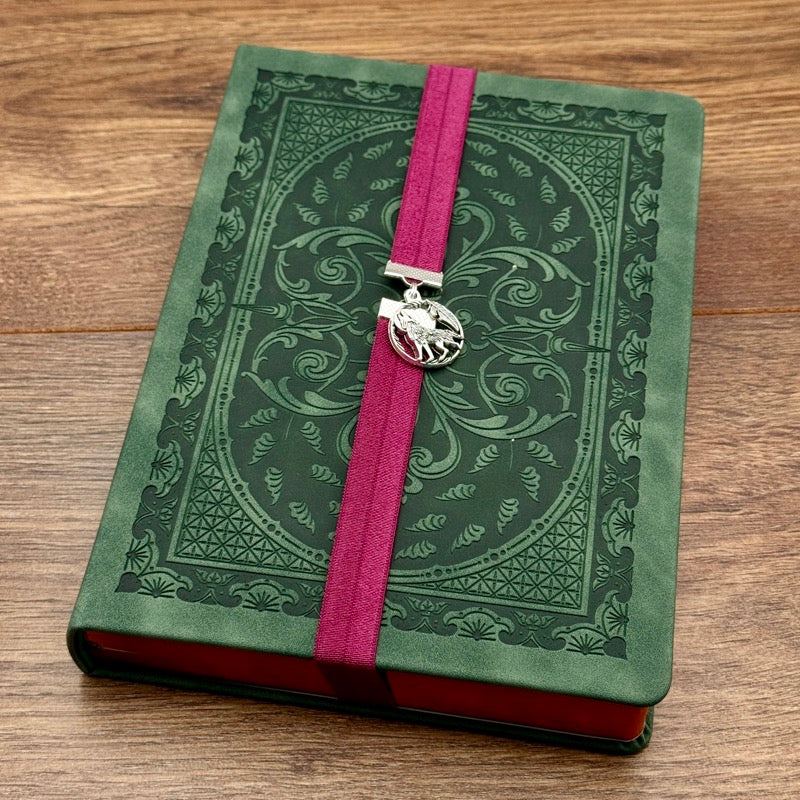 A silver wolf howling at the moon charm on a elastic Bookband