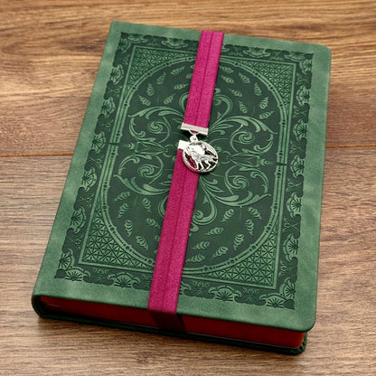 A silver wolf howling at the moon charm on a elastic Bookband