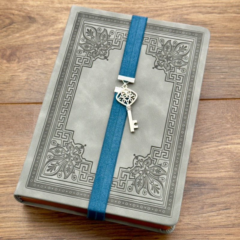 A silver key charm on a elastic Bookband