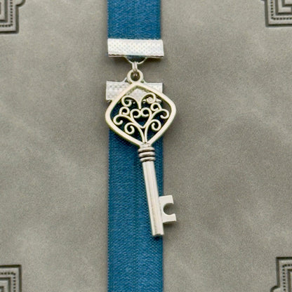 A silver key charm on a elastic Bookband