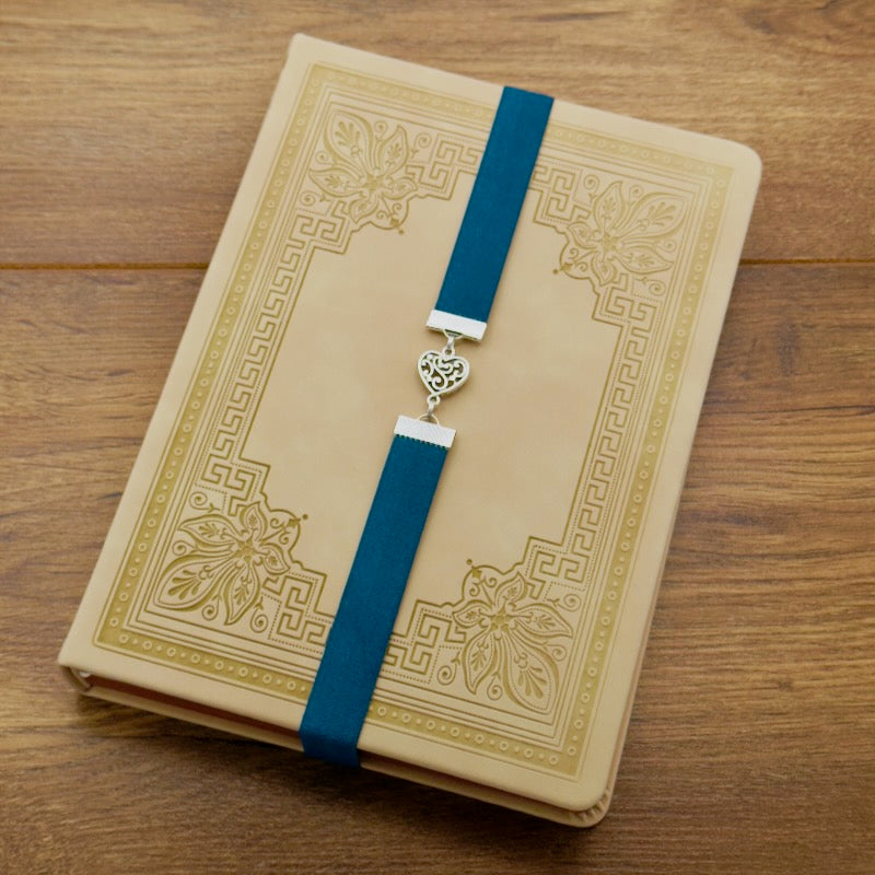 A silver heart charm on an elastic Bookband