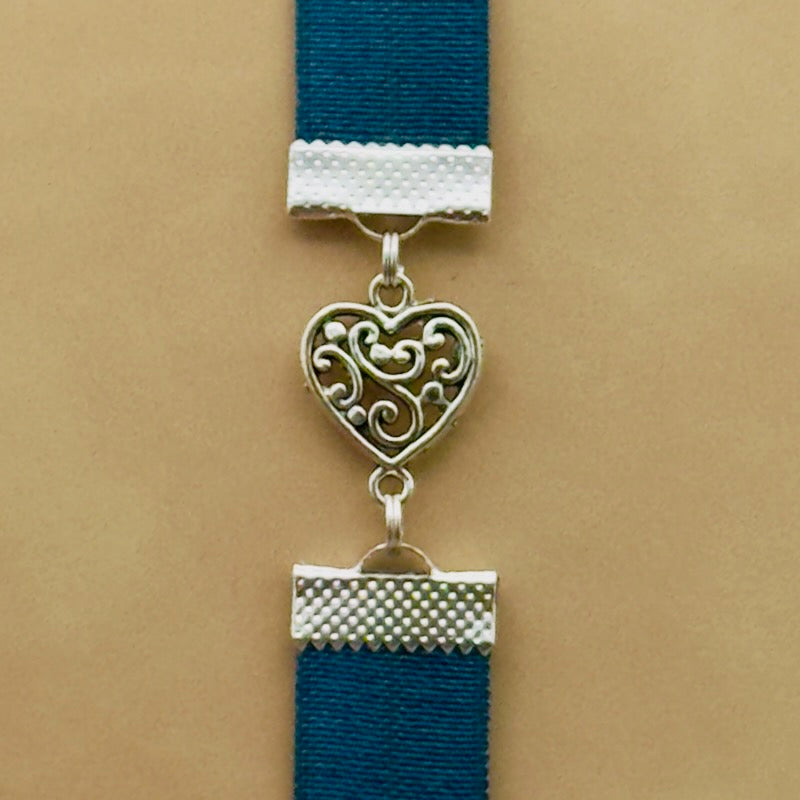 A silver heart charm on an elastic Bookband