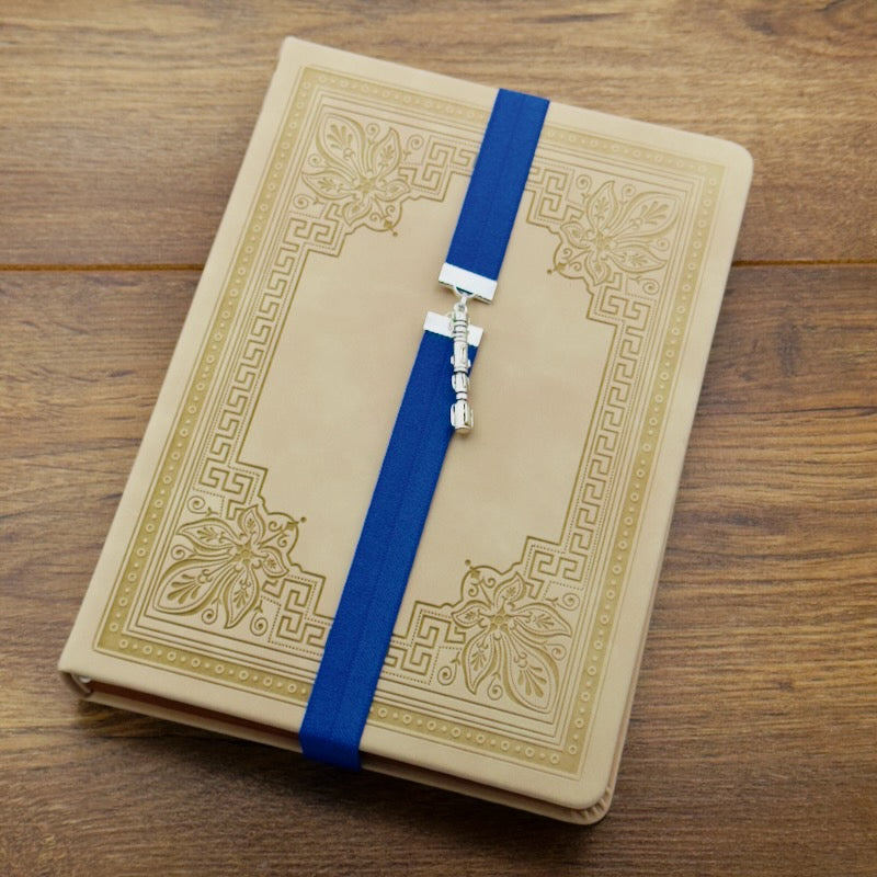 A silver Star Wars Lightsaber charm on a elastic Bookband