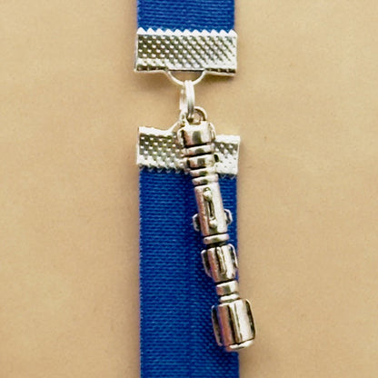 A silver Star Wars Lightsaber charm on a elastic Bookband