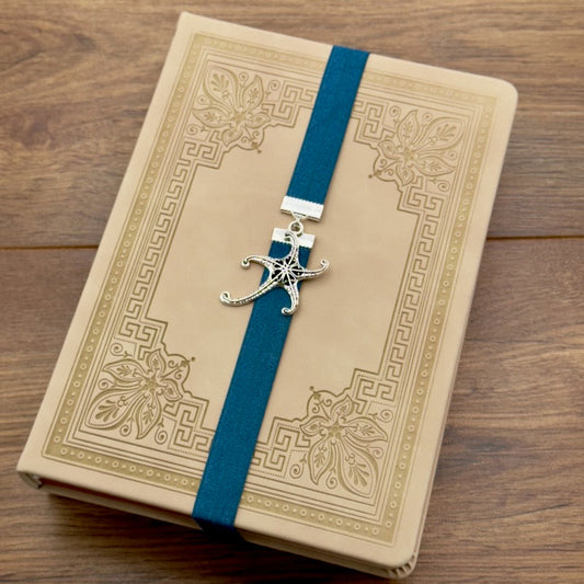 A silver starfish charm on a elastic Bookband