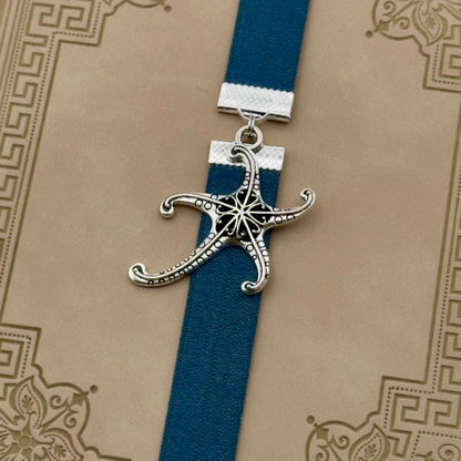 A silver starfish charm on a elastic Bookband
