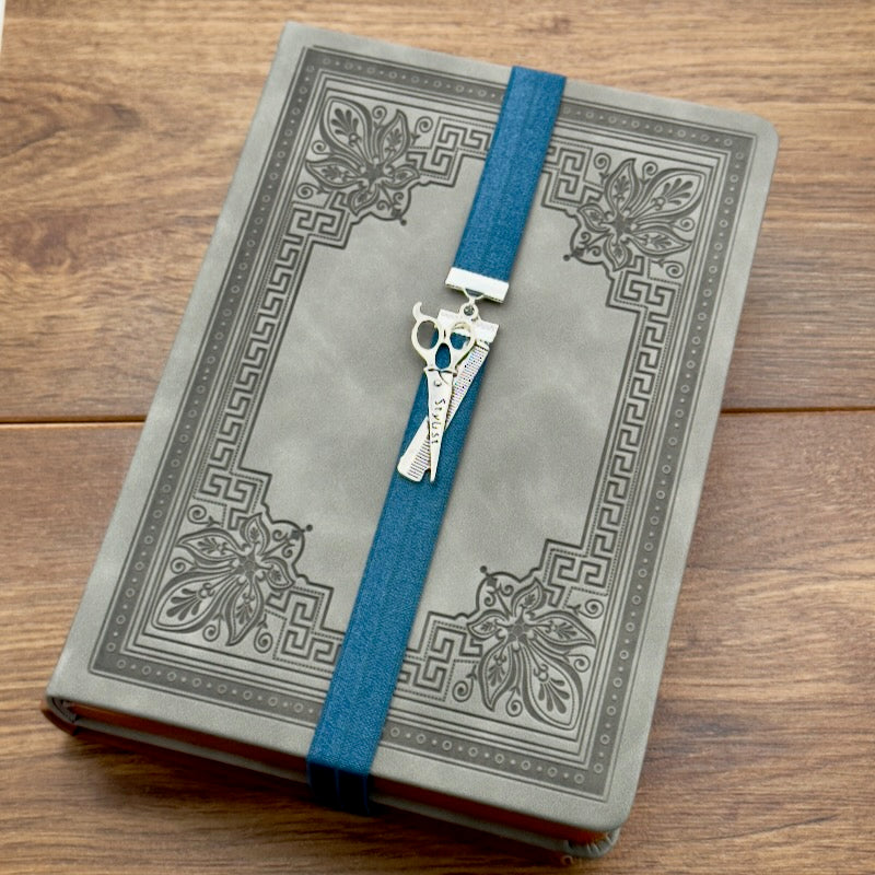 A silver hairstylist scissors and comb charm on a elastic Bookband