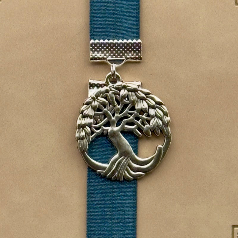 A silver tree of life charm on an elastic Bookband