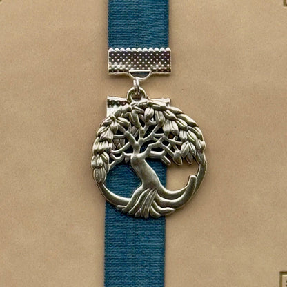 A silver tree of life charm on an elastic Bookband