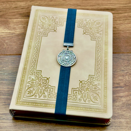 A silver zodiac charm on an elastic Bookband