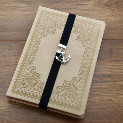 A silver anchor charm on a bookband elastic bookmark