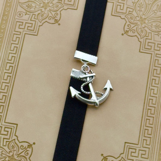 A silver anchor charm on a bookband elastic bookmark