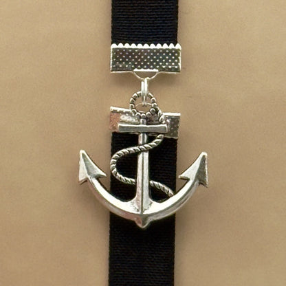 A silver anchor charm on a bookband elastic bookmark