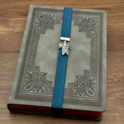 A silver cicada charm on a elastic Bookband