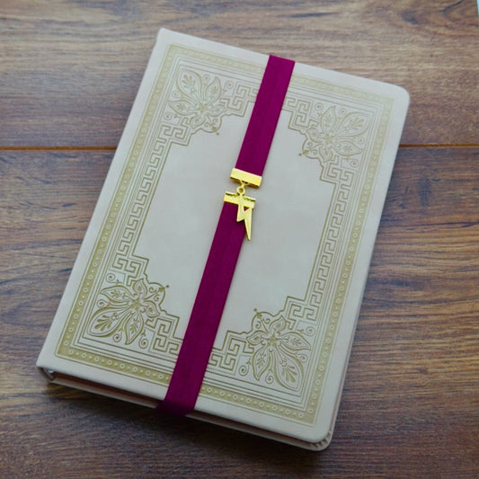 A gold lightning bold charm on an elastic Bookband
