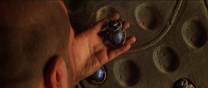 Hand holding a scarab bettle, from the movie The Mummy